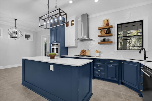 kitchen with wall chimney range hood, a sink, oven, and blue cabinets