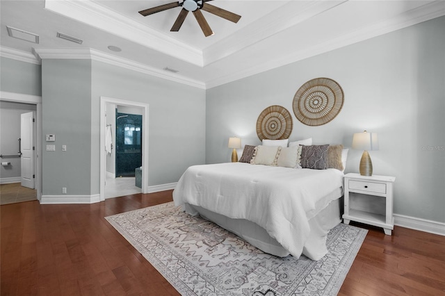 bedroom featuring ornamental molding, hardwood / wood-style floors, a raised ceiling, and baseboards