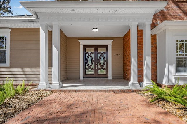 view of exterior entry featuring covered porch