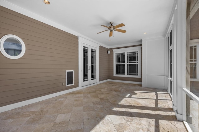 unfurnished sunroom with ceiling fan