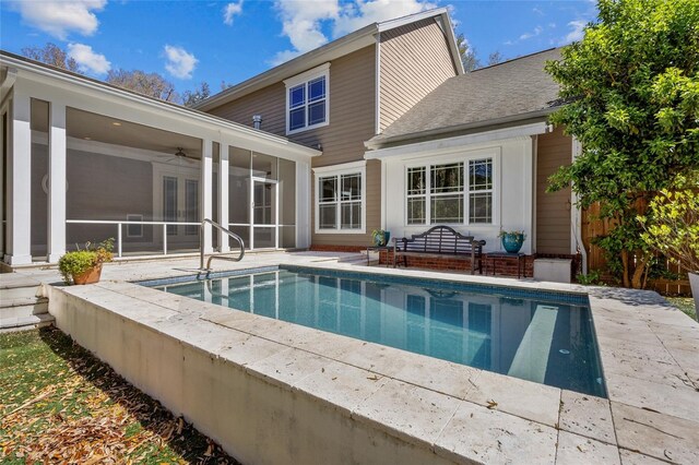 back of property with a shingled roof, a sunroom, ceiling fan, french doors, and a patio area