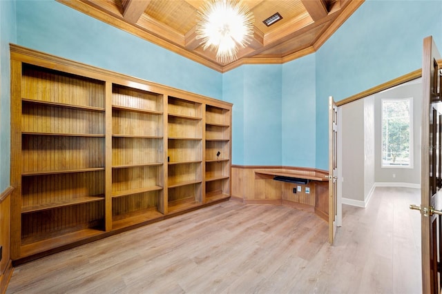 unfurnished office with crown molding, baseboards, beam ceiling, wood finished floors, and coffered ceiling