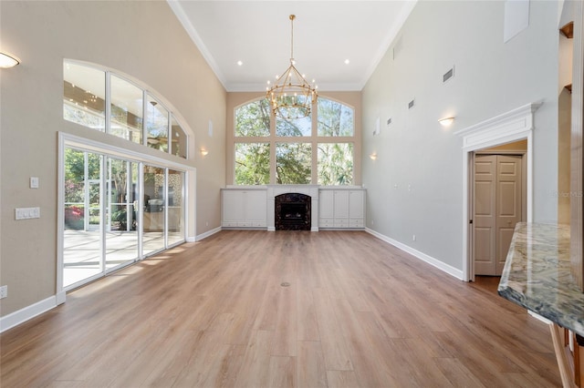 unfurnished living room with light wood-type flooring and baseboards