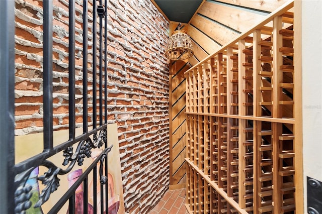 wine area featuring brick floor and brick wall