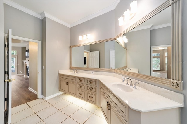 full bath featuring baseboards, double vanity, a sink, tile patterned flooring, and crown molding