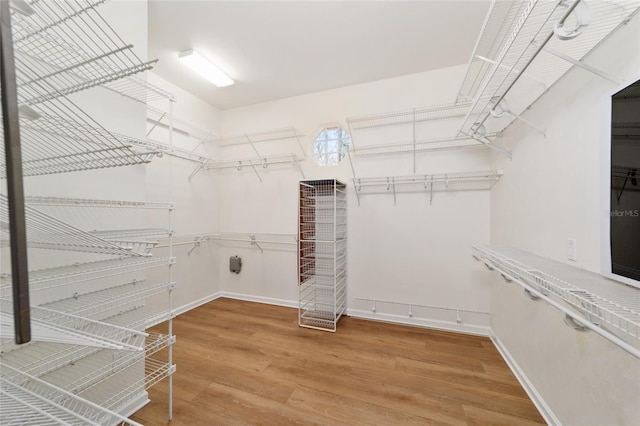 spacious closet with wood finished floors