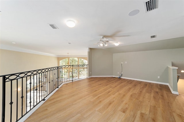 spare room with visible vents, baseboards, and light wood finished floors