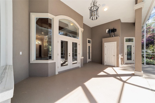 exterior space with french doors and stucco siding