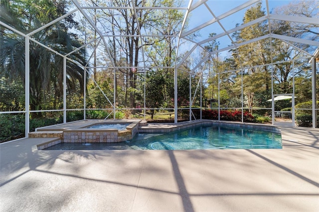 view of swimming pool with glass enclosure, a patio area, and a pool with connected hot tub