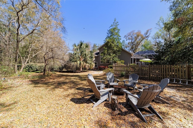 view of yard featuring fence and an outdoor fire pit