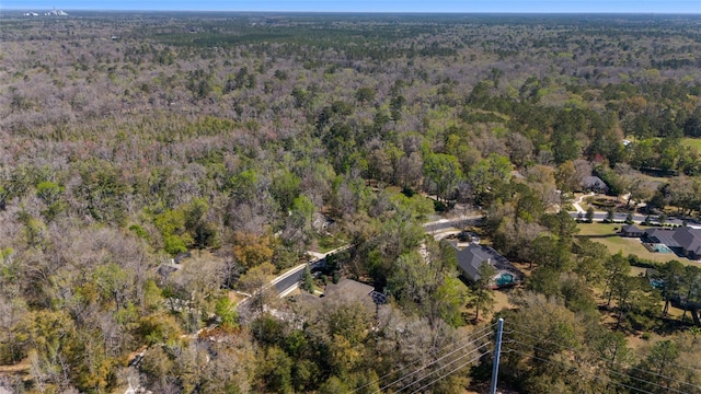 bird's eye view with a wooded view