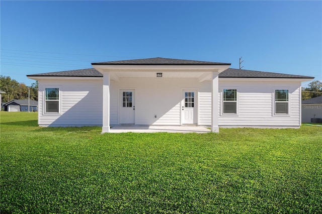 back of house with central air condition unit, a patio area, and a yard