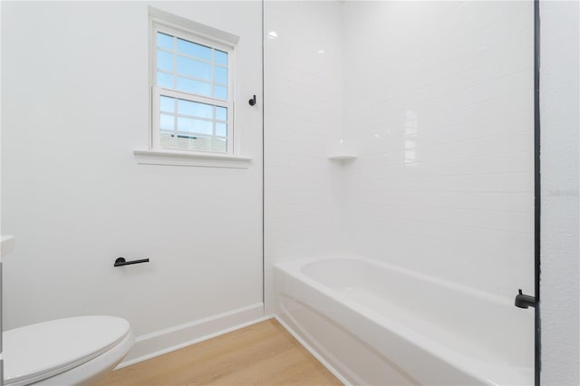 full bath with toilet, baseboards, and wood finished floors