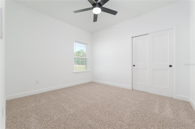 unfurnished room with carpet flooring, ceiling fan, and baseboards