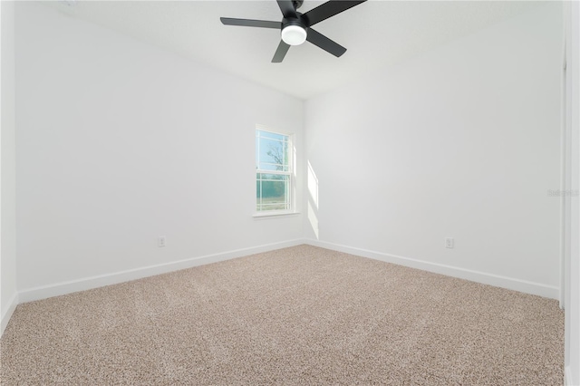 empty room with carpet, ceiling fan, and baseboards