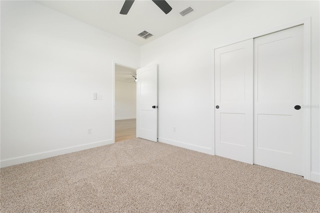 unfurnished bedroom featuring carpet floors, a closet, visible vents, and baseboards