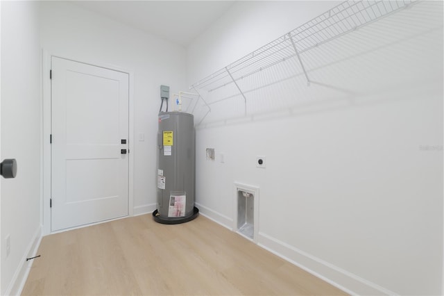 laundry room with electric water heater, hookup for an electric dryer, laundry area, wood finished floors, and baseboards