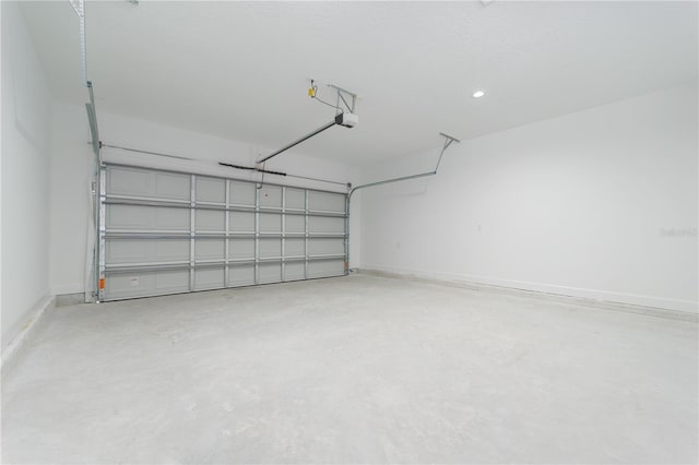 garage with baseboards and a garage door opener