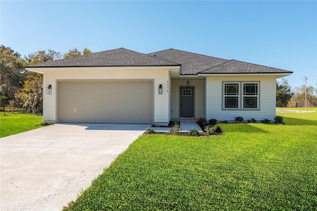 view of front of property with a shingled roof, an attached garage, driveway, and a front lawn