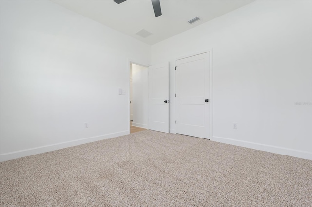 unfurnished room featuring a ceiling fan, carpet, visible vents, and baseboards