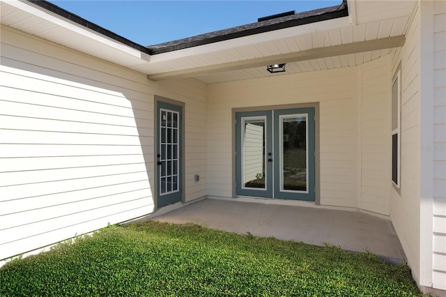 property entrance featuring a patio and french doors