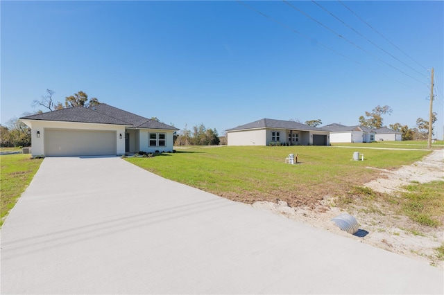 ranch-style house featuring a garage, driveway, and a front lawn