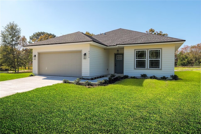 view of front of property featuring a garage, driveway, a shingled roof, and a front yard