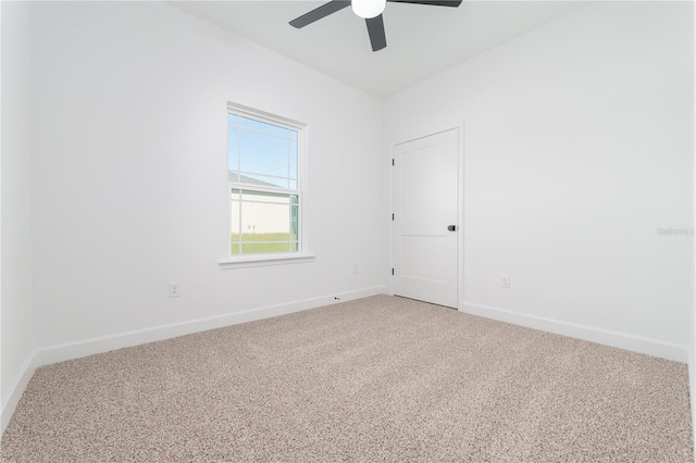 unfurnished room with carpet, a ceiling fan, and baseboards