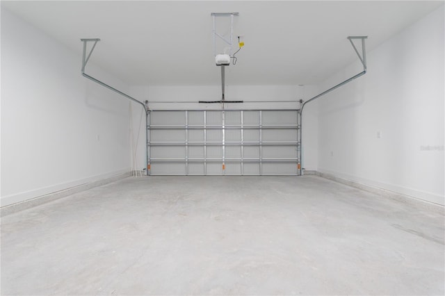 garage with a garage door opener and baseboards