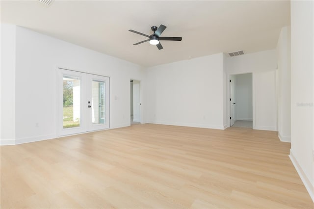 spare room with light wood-type flooring, baseboards, visible vents, and a ceiling fan