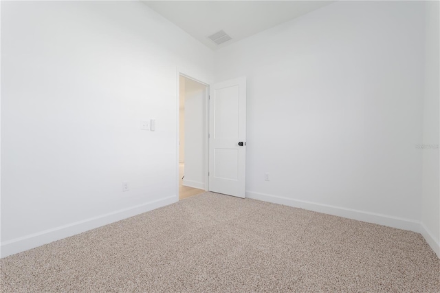 empty room with light carpet, visible vents, and baseboards