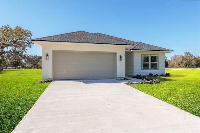 view of front of home with a garage, a shingled roof, a front lawn, and concrete driveway