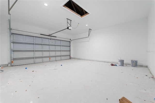 garage featuring a garage door opener and baseboards