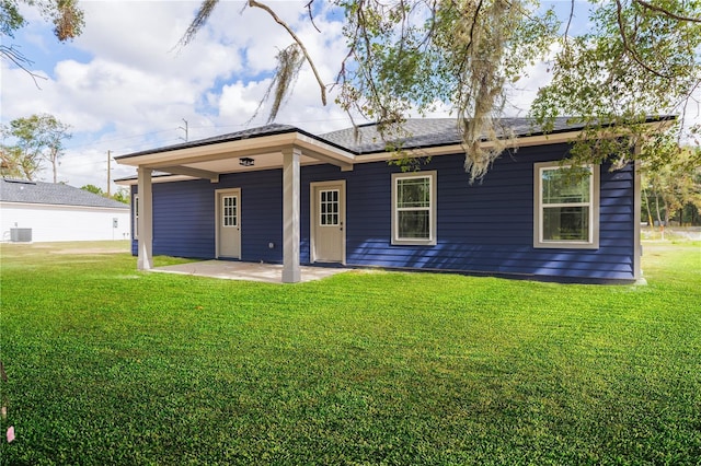 back of house featuring a yard, cooling unit, and a patio