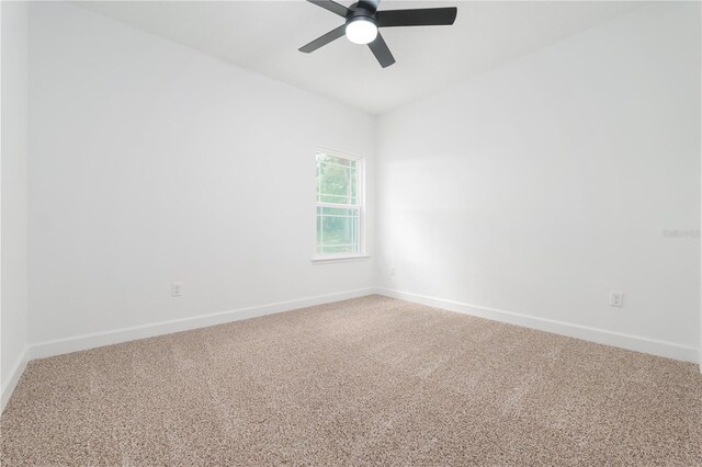 spare room featuring carpet floors, ceiling fan, and baseboards