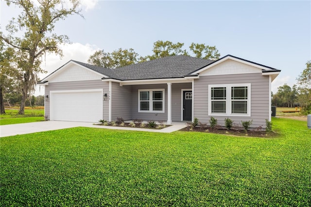 view of front of house with a garage, driveway, a front lawn, and roof with shingles