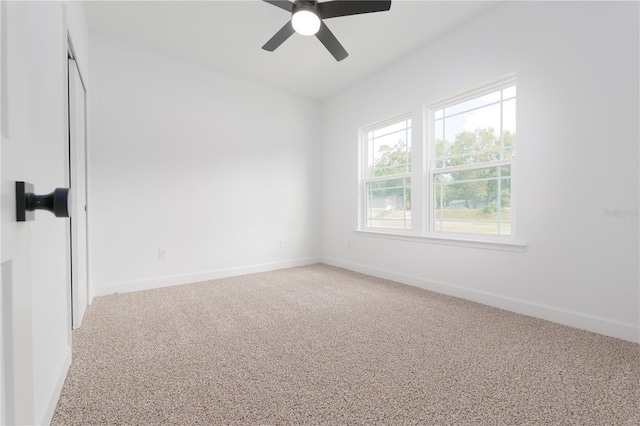 unfurnished room featuring ceiling fan, baseboards, and light colored carpet