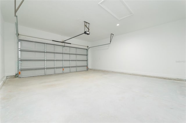 garage featuring a garage door opener and baseboards