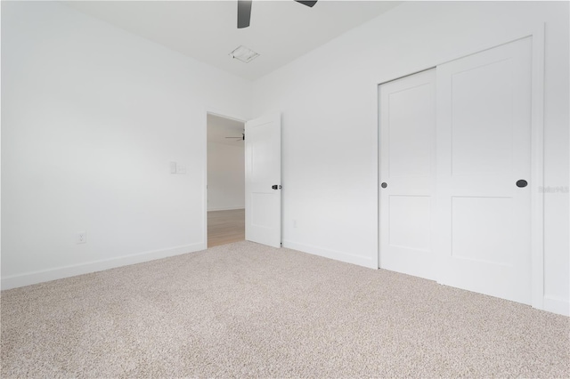 unfurnished bedroom featuring carpet floors, a closet, ceiling fan, and baseboards