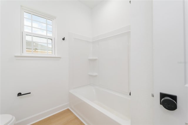 full bath featuring wood finished floors, toilet, and baseboards