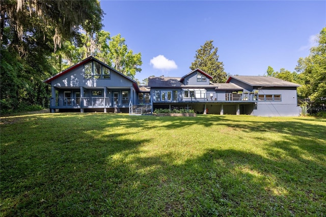 back of property with a lawn and a wooden deck