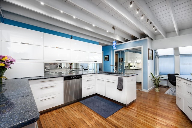 kitchen featuring a sink, modern cabinets, a peninsula, and stainless steel dishwasher