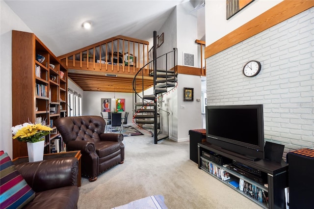 carpeted living area with baseboards, stairs, and high vaulted ceiling