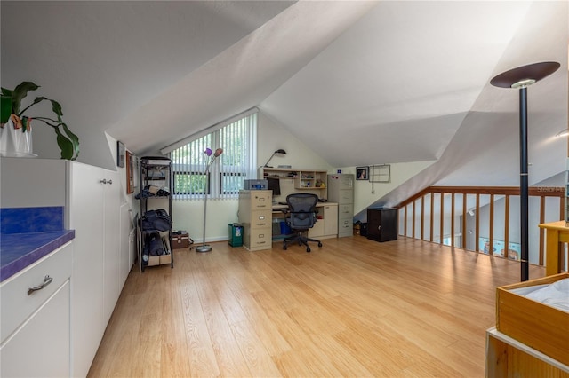 office space with vaulted ceiling and wood finished floors