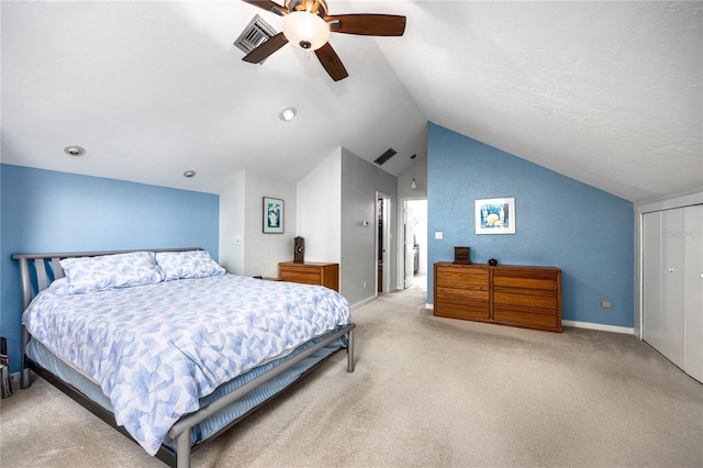 bedroom with carpet floors, visible vents, vaulted ceiling, and a ceiling fan