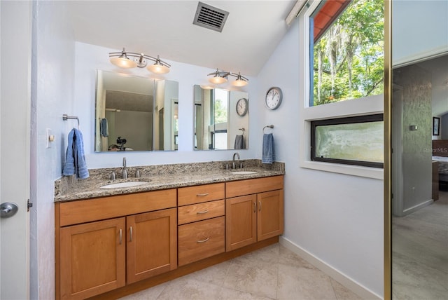 full bathroom with double vanity, visible vents, a sink, and lofted ceiling