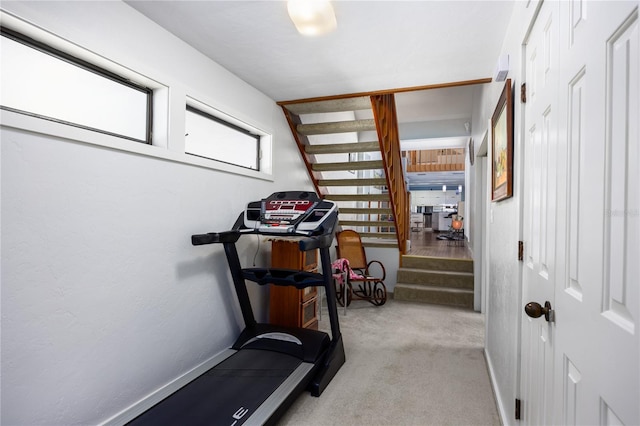 exercise room featuring carpet floors and baseboards