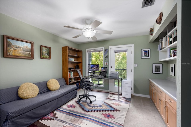 office with light carpet, ceiling fan, visible vents, and baseboards