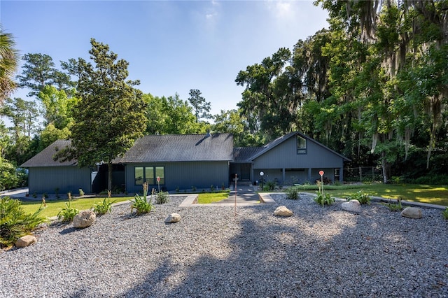 view of front of home with driveway and a front lawn