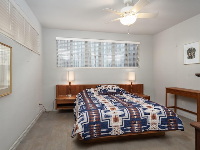 bedroom with ceiling fan and baseboards